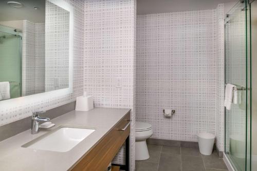 a white bathroom with a sink and a toilet at Hampton Inn By Hilton St Louis Airport in Saint Louis