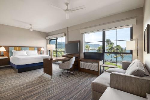 a hotel room with a bed and a desk at Hampton Inn & Suites Maui North Shore in Kahului