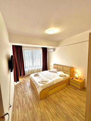 a hotel room with a bed and a window at Summerland Seaview Apartments in Mamaia