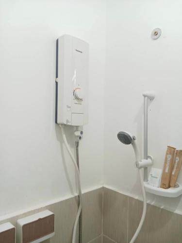 a shower in a bathroom with a hose at Olango Island - Tiny Guest House - S&E-3 in Lapu Lapu City