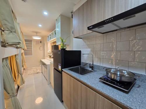 a kitchen with a sink and a counter top at Studio Unit with 4 Fun Bunk Beds in Iloilo City