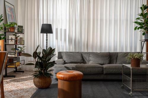 a living room with a couch and some plants at HOTEL GIARDINO in Cesenatico