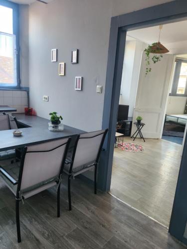 une salle à manger avec une table et des chaises dans une pièce dans l'établissement Laelia place Rivotte, à Besançon