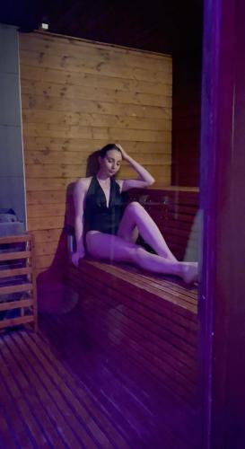 a woman sitting on a bench in a room at Fratelli Clemente Spa and Hotel in Castelvetrano Selinunte