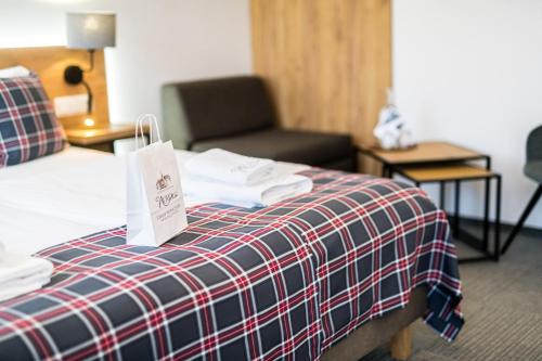 a hotel room with a bed and a chair at Nowa - Ski SPA Hotel in Karpacz
