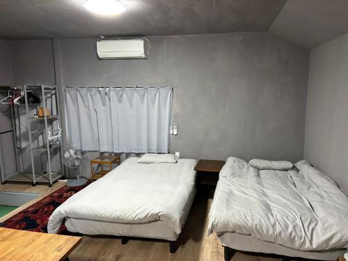 Postel nebo postele na pokoji v ubytování NagataSeaTime