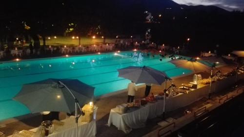 a person standing in a swimming pool at night at La Cerasa in Contigliano