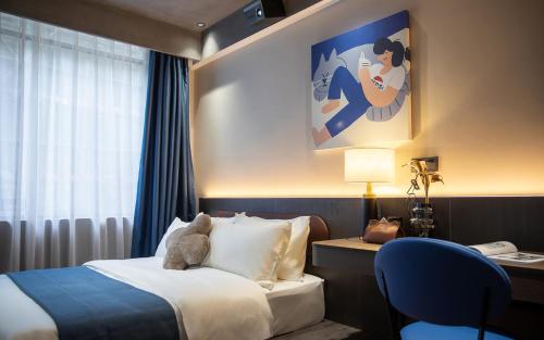 Ένα ή περισσότερα κρεβάτια σε δωμάτιο στο Tami Hotel Beijing Road Memorial Tower Subway Station Branch