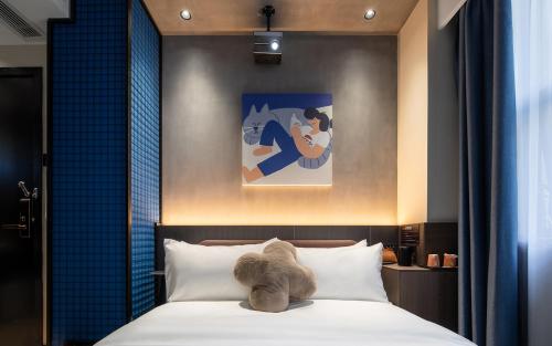 Ένα ή περισσότερα κρεβάτια σε δωμάτιο στο Tami Hotel Beijing Road Memorial Tower Subway Station Branch
