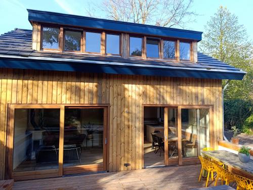 a house with glass doors and a deck at Juneberry Ecolodge Bergen in Bergen