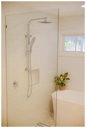 a shower with a glass door in a bathroom at Garden View Cottage in Stanley