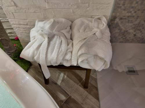 a pile of towels sitting on a table in a bathroom at Sus e Sott B&B in Mottola