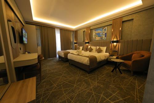 a hotel room with a bed and a chair at Mir Emir Hotel in Bostaniçi
