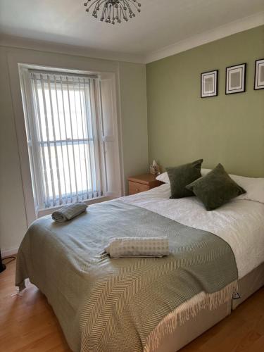 a bedroom with a large bed with a chandelier at Lovely 2-bedroom apartment in Scottish Borders in Earlston
