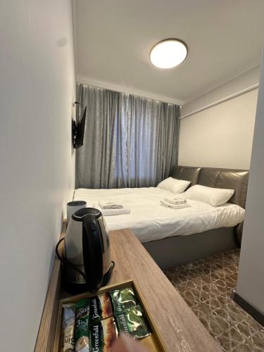 a room with two beds and a table with a tv at Asman in Naryn