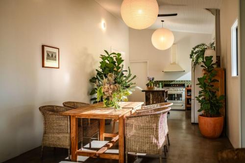 a dining room with a wooden table and chairs at Off-Grid Eco Cabin in Bellingen