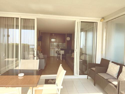 a dining room and living room with a table and chairs at Sunny Home Costa Plana-Monaco -Cap D'Ail in Cap d'Ail