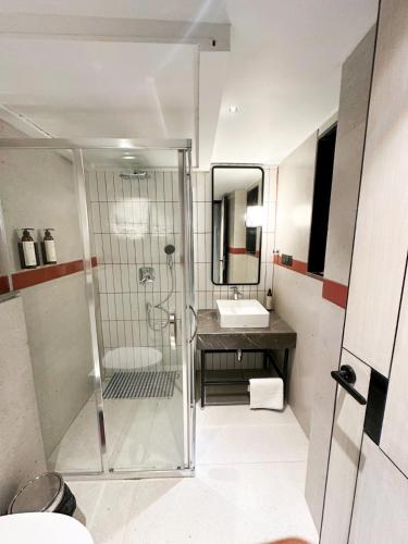 a bathroom with a shower and a sink at Checkmate in Mussoorie