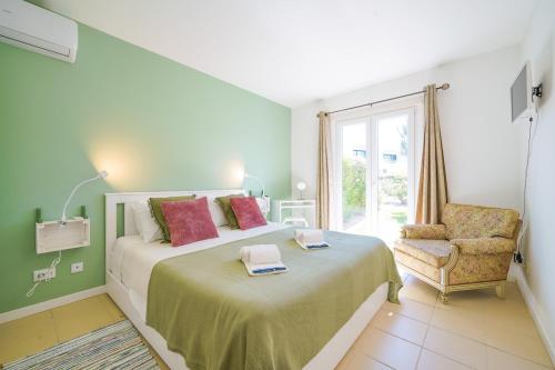 a bedroom with a bed and a chair and a window at HideAway by MOJE Holiday in Porches