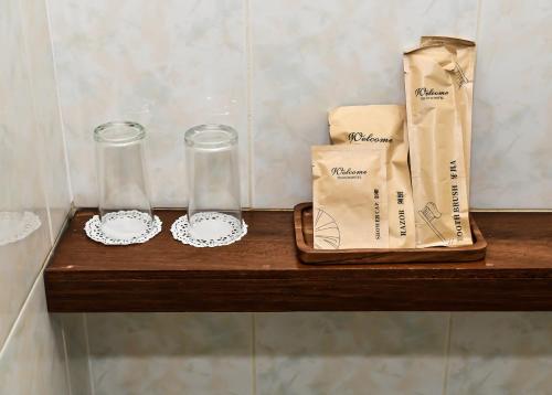 a wooden shelf with two glasses and a bag on it at The Beehive in Male City