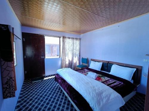 a bedroom with a large bed in a room at Native Retreat Cottage Lukung in Lukung