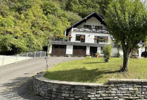 a house with a tree in front of it at Apartment Jobelius in Beilstein
