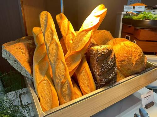 a tray filled with lots of different types of bread at Wyndham Garden Phuket Kamala in Kamala Beach