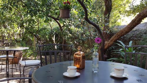 a table with two cups and a bottle on it at Turtle Apartments in Dubrovnik