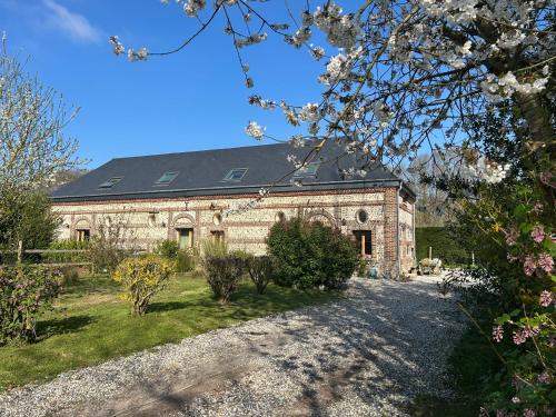 a large stone building with a black roof at L'Echo de la nature in Sasseville