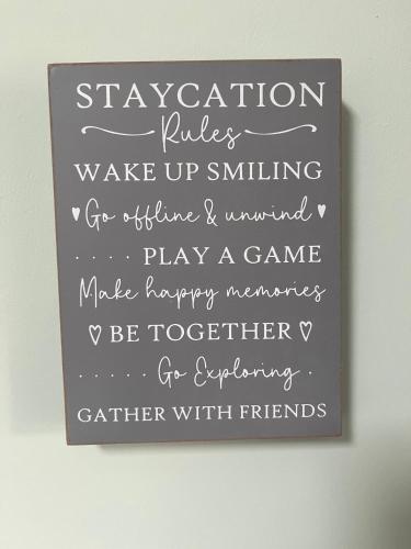 a chalkboard sign with the words vacation rules wake up smiling at The Snuggery Broadclyst in Exeter
