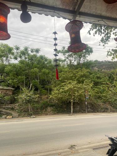 a view of a street with bells hanging from a building at ROSIE HOMESTAY Hà Giang in Ha Giang