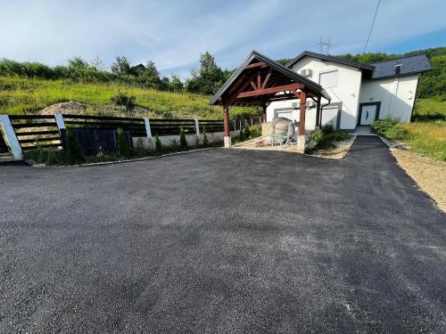 a parking lot in front of a white building at Overland villa 1 in Ilijaš