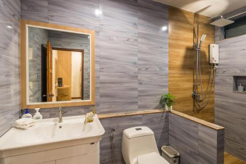 a bathroom with a toilet and a sink and a mirror at Pin thong pool villa in Ao Nang 