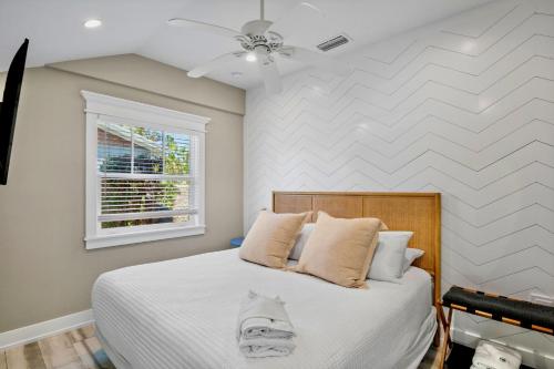 a bedroom with a bed and a window at Villa #4 Sand Dollar in Holmes Beach