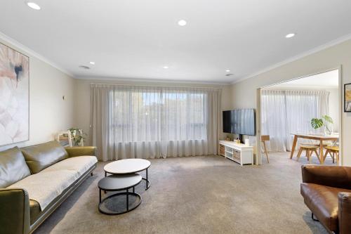 a living room with a couch and a table at Urban and Stunning 3 bed Home in Hutt Central in Lower Hutt