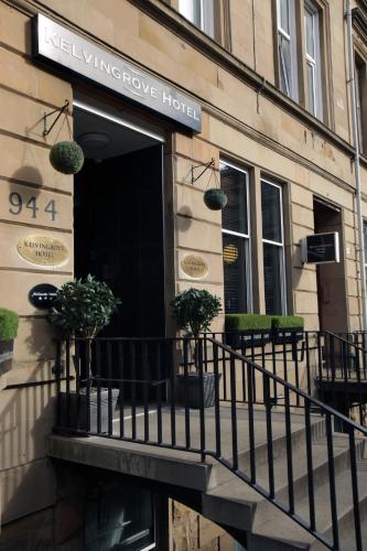a building with a balcony with potted plants on it at Kelvingrove Hotel - Sauchiehall St in Glasgow