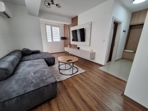 a living room with a couch and a table at Premium Central Skopje Apartments & Free Private Parking in Skopje