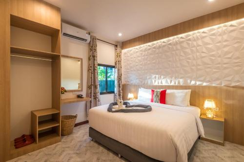 a bedroom with a large bed and a window at Pin thong pool villa in Ao Nang 