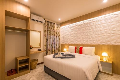 a hotel room with a bed and a mirror at Pin thong pool villa in Ao Nang 