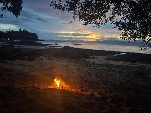 a bonfire on the beach at sunset at Island Life Bungalows in Ko Khan