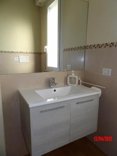 a bathroom with a white sink and a mirror at Casa Baia in Pesaro