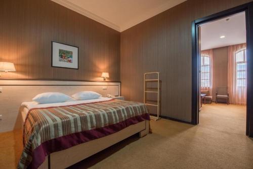 Postel nebo postele na pokoji v ubytování Hotel Rike park