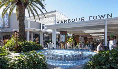 a shopping center with a large pool in front of a store at Broadwater Parklands Paradise in Gold Coast