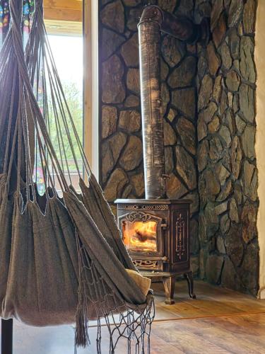 a wood stove in a room with a stone wall at Bieszczadzka Hawira - w Centrum przy Jeziorze z Widokiem dla Rodzin in Polańczyk