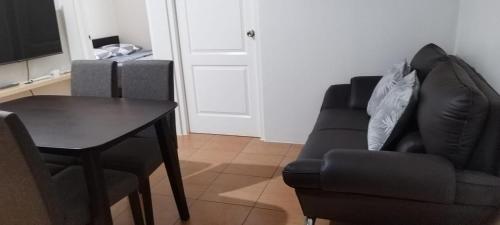 a living room with a table and a couch and a chair at San Remo Oasis in Cebu City
