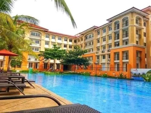 a large swimming pool in front of a building at San Remo Oasis in Cebu City