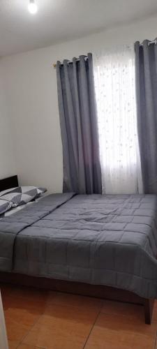 a bed in a room with a window at San Remo Oasis in Cebu City