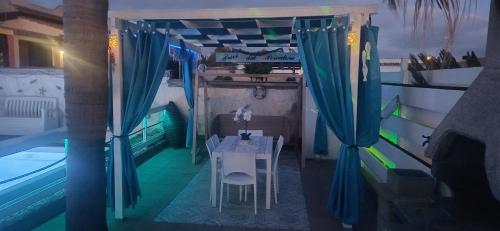 a table and chairs in a room next to a pool at Alloggi Turistici con Piscina Palestra Jacuzzi Sauna - All Inclusive in Anzio
