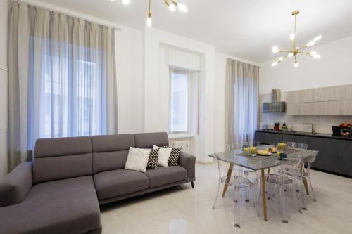a living room with a couch and a table at Genoa Lux Apartments with parking in Genova