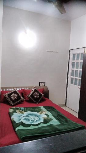 a bedroom with a bed with at Om Datta Krupa Niwas Cottage in Mahabaleshwar
